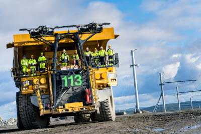 Employees on electric mine truck